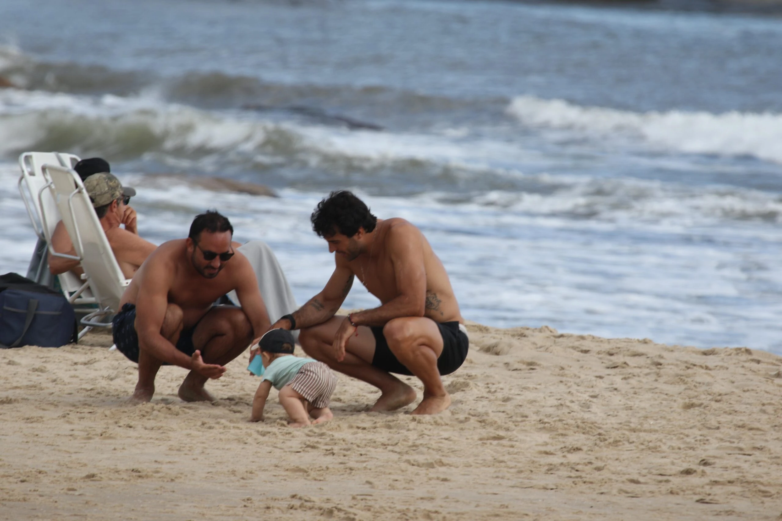 Manu Urcera con Cruz gateando en la playa