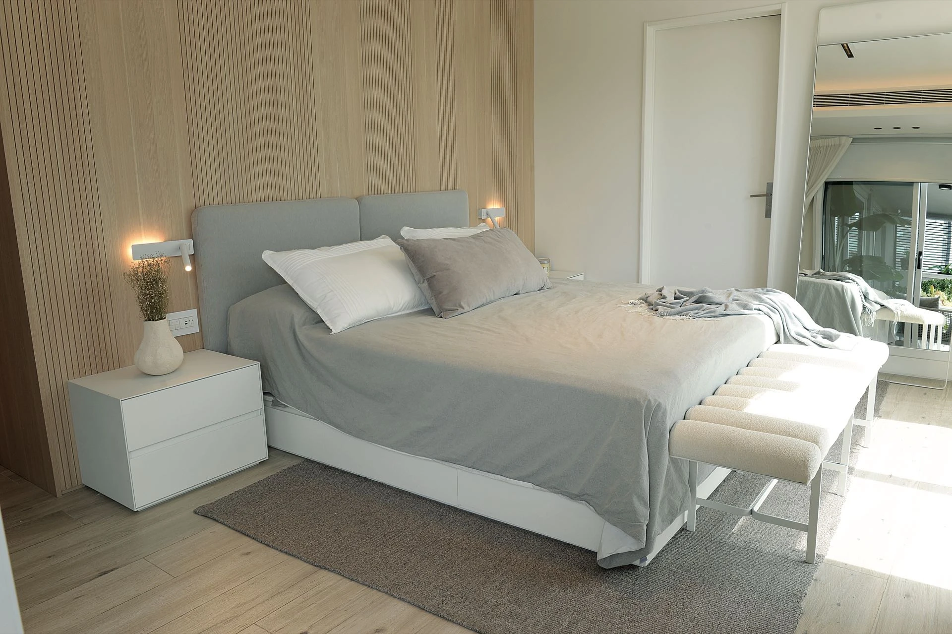 El dormitorio principal envuelto en un revestimiento de tono claro.