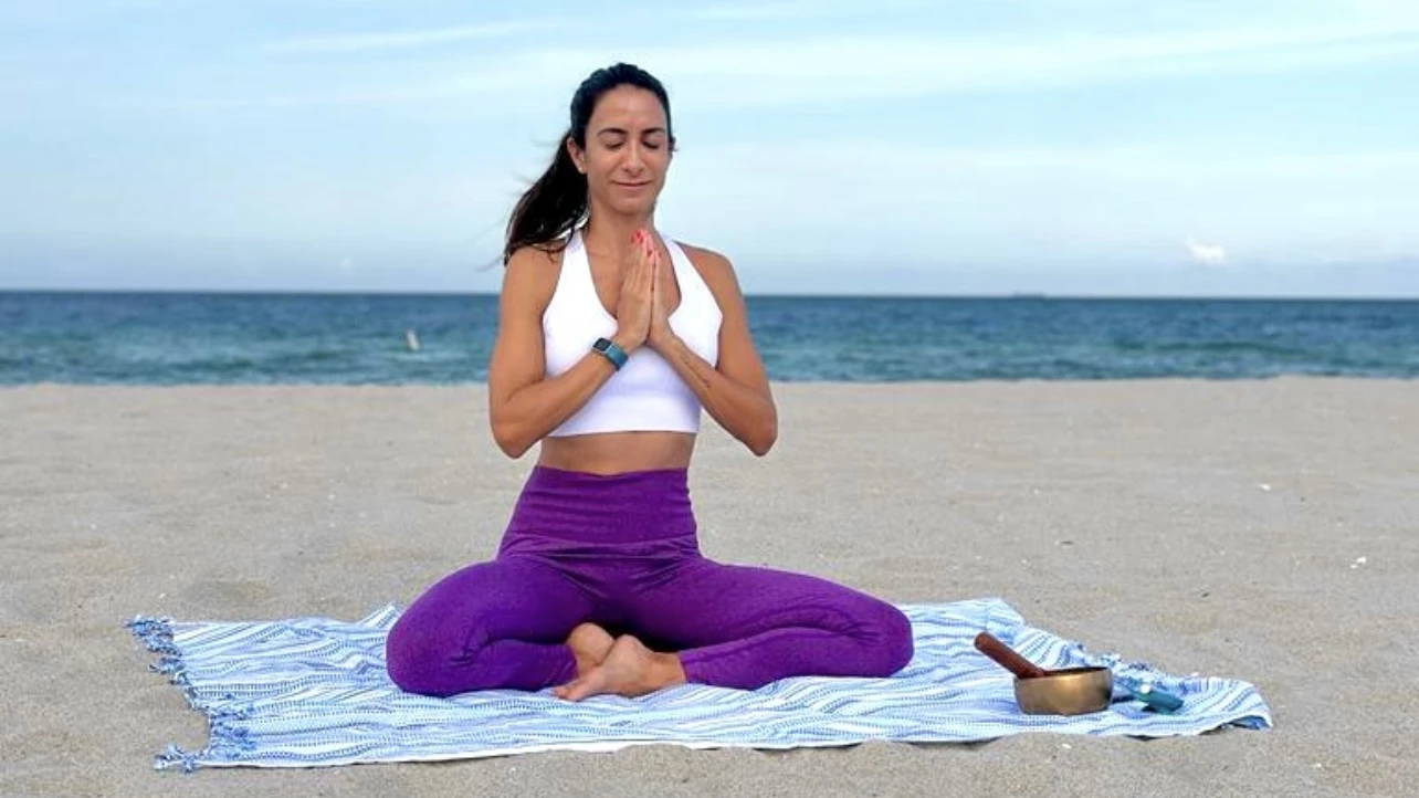 Meditar ya no es esotérico: es entrenamiento para el cerebro

Sentarte, cerrar los ojos y seguir la respiración durante unos minutos puede sonar simple. Pero, puertas adentro, pasan muchas cosas. Hoy se sabe que la meditación modifica estructuras y circuitos cerebrales: aumenta el espesor de la corteza prefrontal -clave para la atención y la toma de decisiones- y reduce la reactividad de la amígdala, la región que se activa frente al estrés y la amenaza.

“Meditar es entrenar la mente, no ‘quedarse en blanco’”, explica la psicóloga y sexóloga Florencia Faiatt, creadora de My Yoga Flower (yoga basado en ciencia). Igual que cuando levantás pesas, cada vez que llevás la atención de vuelta a la respiración o al cuerpo, reforzás los circuitos que sostienen el foco y la regulación emocional.

Además, la práctica activa el sistema nervioso parasimpático, responsable del modo “descanso y recuperación”: baja la frecuencia cardíaca, la respiración se vuelve más profunda y el cuerpo entra en un estado de reparación fisiológica.

La atención como músculo: lo que muestra la neurociencia

Uno de los hallazgos más claros de los últimos años es que la atención se puede entrenar. Estudios con imágenes cerebrales y registros eléctricos muestran que incluso intervenciones breves de meditación mejoran el control atencional y la eficiencia cognitiva.

Lejos de la idea de “mente en blanco”, la práctica consiste en esto:

Notás que tu mente se fue (a la lista del súper, a un mail pendiente, a una preocupación).

Te das cuenta.

Volvés con amabilidad al foco elegido (la respiración, el cuerpo, un sonido).

Ese ir y venir, lejos de ser un “fracaso”, es el entrenamiento. Con el tiempo, las personas que meditan con regularidad muestran menos reactividad de la amígdala frente a estímulos emocionales y una mayor conexión con áreas prefrontales involucradas en la regulación de emociones.

De reaccionar en automático a responder con calma

Más allá de las imágenes de laboratorio, el efecto se nota en lo cotidiano. La meditación fortalece la capacidad de observar lo que pasa antes de actuar: un enojo, un miedo, un pensamiento catastrófico. En vez de reaccionar en piloto automático, aparece una pequeña pausa interna.

Esa micropausa se traduce en habilidades muy concretas:

responder sin tanta impulsividad,

poner límites con menos culpa,

tomar decisiones desde un lugar más claro,

salir del “ruido mental” constante.

Investigaciones recientes resumen este efecto como una mejora en la regulación emocional y en la resiliencia al estrés: menos activación de los circuitos de alarma, más participación de las áreas que ayudan a dar contexto, entender lo que pasa y elegir una respuesta.

Empezar es incómodo (y eso también es parte del proceso)

Las primeras prácticas rara vez son como las fotos de catálogo: aparecen tareas pendientes, el cuerpo se inquieta, la mente se dispersa. “No significa que lo estés haciendo mal, significa que estás empezando”, subraya Faiatt.

Así como nadie levanta 20 kilos el primer día en el gimnasio, nadie medita cinco minutos con calma absoluta desde el inicio. La evidencia muestra que la constancia pesa más que la duración: cinco o diez minutos diarios tienen más impacto que una sesión larga cada tanto.

Con el tiempo:

la mente se aquieta más rápido,

el cuerpo reconoce el “modo descanso”,

la práctica pasa de ser un esfuerzo a convertirse en un refugio.

En Para Ti ya te contamos cómo sumar rituales de autocuidado a la rutina nocturna y cómo armar espacios de relax en casa: la meditación puede integrarse perfectamente a ese momento, junto con una infusión, una música suave o una luz más baja.

Cinco pasos simples para empezar a meditar en casa

No hace falta tener experiencia previa ni equipamiento especial. La propuesta de Florencia Faiatt para dar los primeros pasos es clara y realista:

1. Elegí una postura posible
Podés sentarte en una silla, en un almohadón en el piso o recostarte si estás muy cansada. Lo importante es que la columna esté erguida pero relajada, con hombros sueltos y abdomen flojo para que la respiración fluya.

2. Observá la respiración
No intentes forzar nada. Notá cómo entra y sale el aire. Cuando te distraigas (va a pasar muchas veces), registralo y volvé a la respiración. Ese regreso constante es el corazón de la práctica.

3. Sumá un escaneo corporal
Si querés variar, recorré mentalmente el cuerpo: cabeza, cuello, hombros, pecho, abdomen, manos, piernas, pies. Solo observá sensaciones (tensión, calor, cosquilleo) sin intentar cambiarlas. Es una forma sencilla de anclarte al presente.

4. Empezá por poco tiempo
Cinco minutos al día alcanzan para iniciar. Podés usar una alarma suave o una meditación guiada breve. La clave es la regularidad, no la perfección.

5. Cerrá con amabilidad
Al terminar, inhalá profundo por la nariz, exhalá lento y reconocé internamente que te regalaste ese momento. Esa asociación positiva ayuda a sostener el hábito.

Meditación, salud mental y vida cotidiana

La meditación no borra los problemas ni reemplaza tratamientos psicológicos o psiquiátricos, pero sí puede complementar cualquier proceso: ayuda a bajar el nivel basal de estrés, mejora la calidad del descanso y facilita la toma de decisiones desde un lugar menos reactivo. Programas basados en mindfulness, como la reducción del estrés de Jon Kabat-Zinn, ya se usan en hospitales y centros de salud en el mundo para acompañar ansiedad, dolor crónico y otros cuadros.

En un mundo acelerado, aprender a pausar deja de ser un lujo para convertirse en una herramienta de autocuidado y salud mental accesible. Unos minutos diarios pueden cambiar la forma en la que pensás, sentís y te relacionás con lo que te rodea. Y ese cambio, según la ciencia, se sostiene en el tiempo.