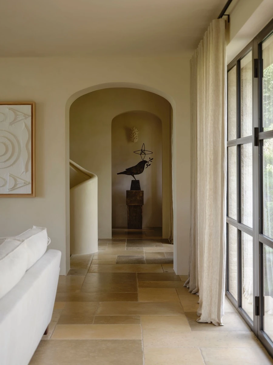 Al final del pasillo que lleva a la escalera destaca una escultura totem vintage de un ave realizada por Sophie Setch.  