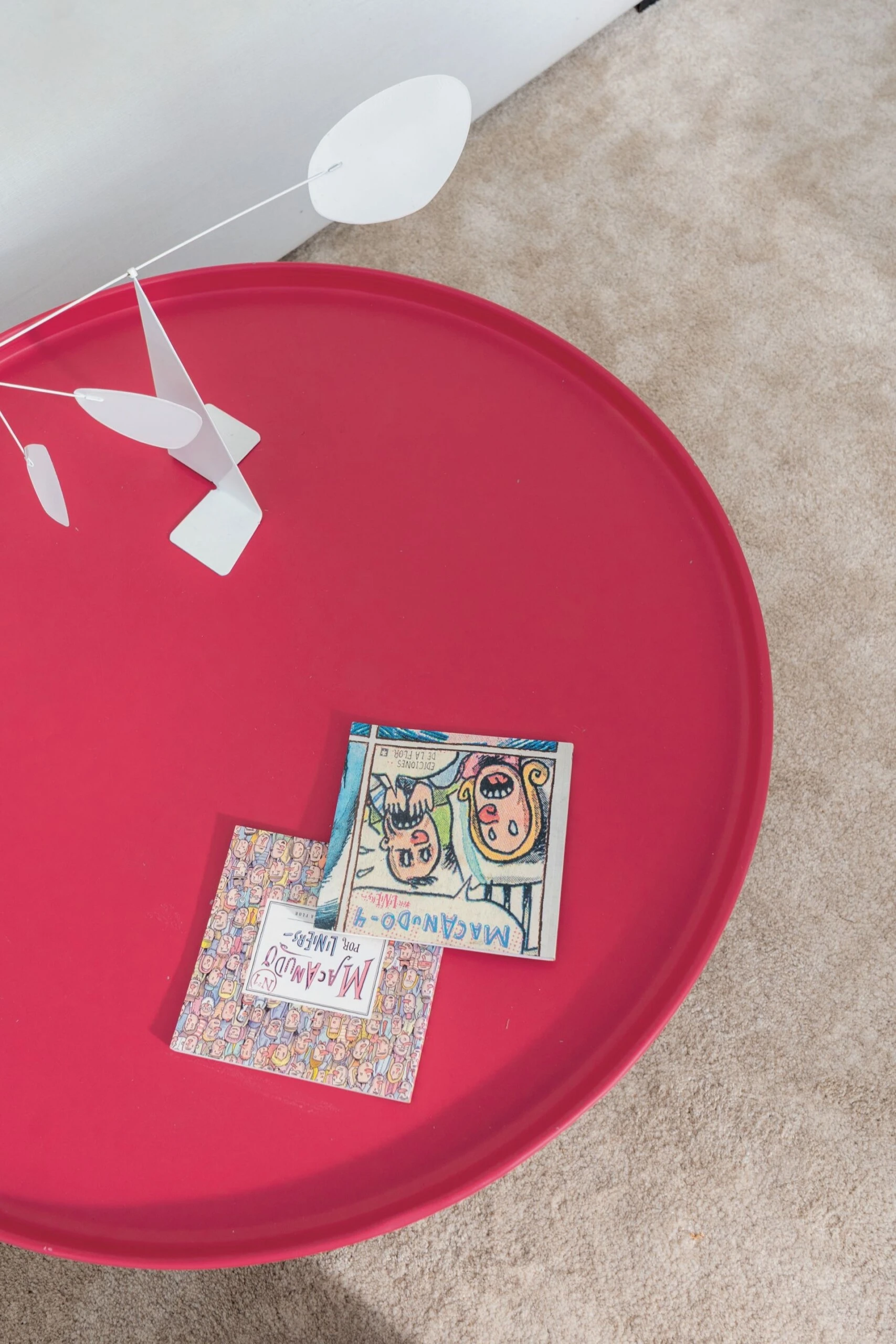 La mesa baja en rojo vibrante, detalle de diseño del departamento.