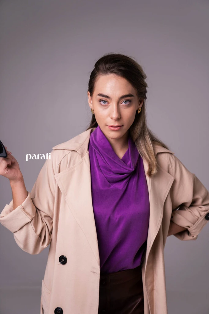 Trench de gabardina liviana color beige @concepcion.b.a; top musculosa de cupro y viscosa, con cuello alto @claraibargurenoficial; falda de cuero marrón con botones delanteros @mv.leather.studio; zapatos marrones taco fino, bajo @mishkabuenosaires; aros dorados @tina.allo; anteojos cat eyes marco negro @absurda_optica