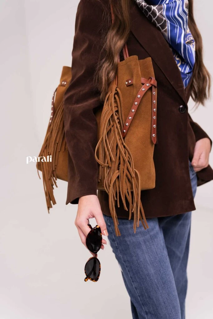 Blazer efecto gamuza, entallado @markovaoficial; pañuelo estampado, aros plateados y anteojos de sol @tina.allo; jean recto @verapasionadas; bolso gamuzado con flecos y tachas @oggizapatos y botinetas animal print snake @mishkabuenosaires.