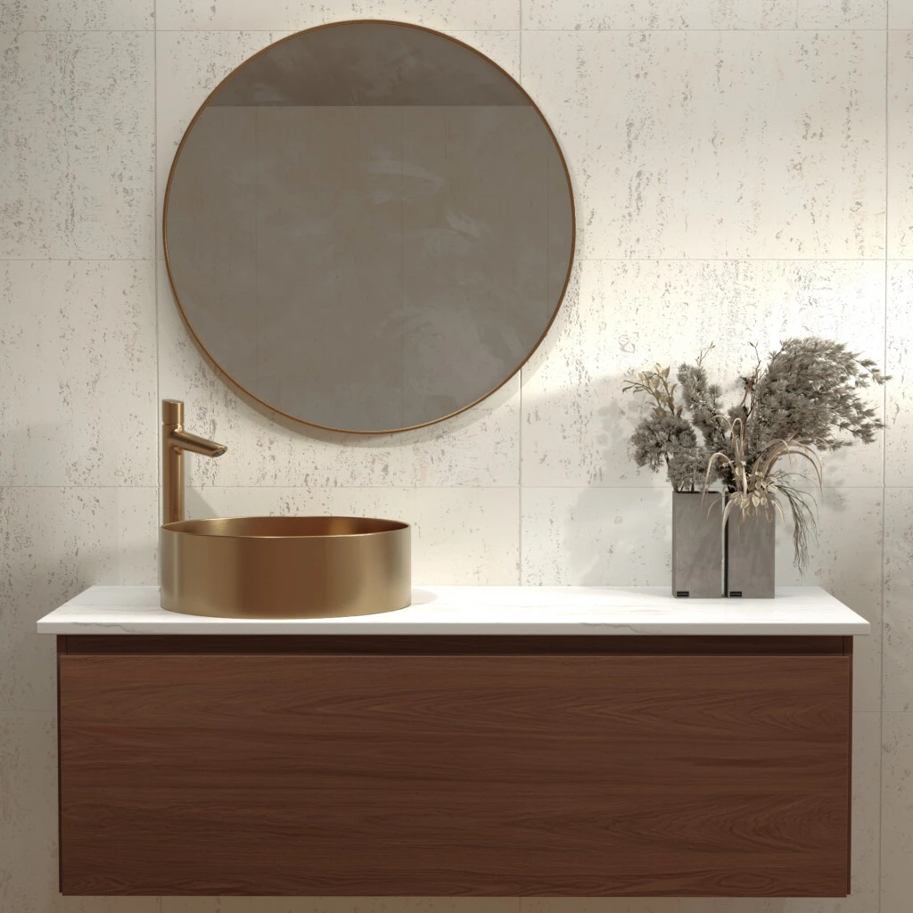 Grifería FV línea Cilindra en acabado Brushed Brass sobre bacha de baño de diseño.