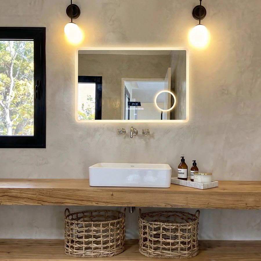 Espejo inteligente para baño con iluminación LED integrada, funciones táctiles y diseño minimalista sobre una bacha moderna.