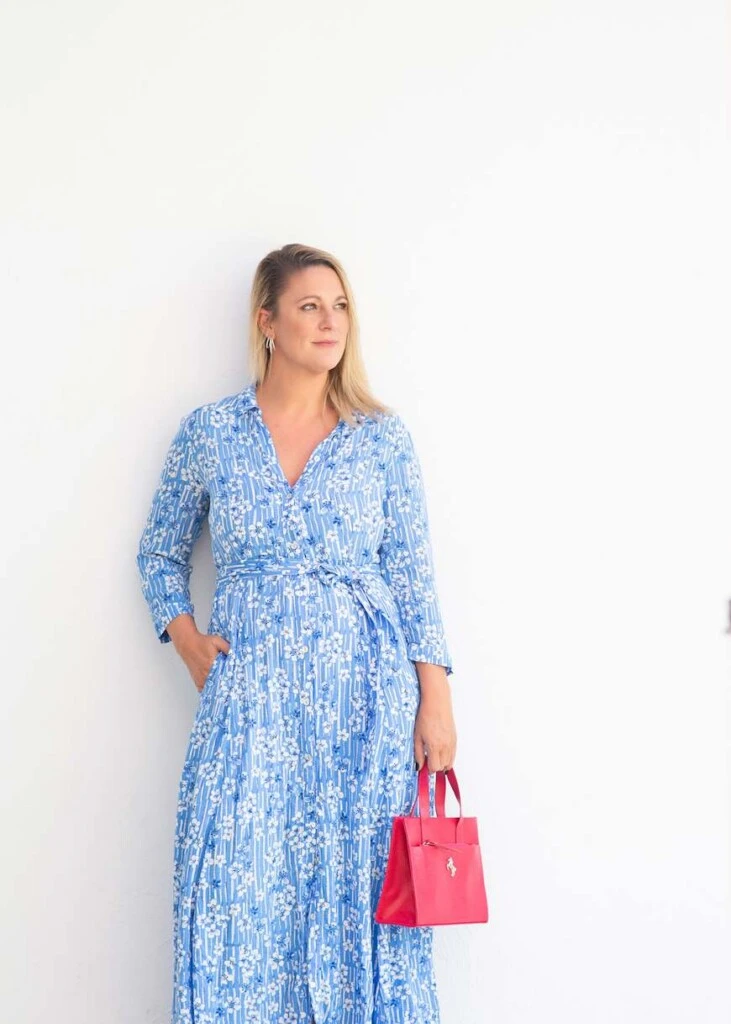 Lía Protto luce una cartera fucsia de Tentroya junto a un look de inspiración femenina y contemporánea.