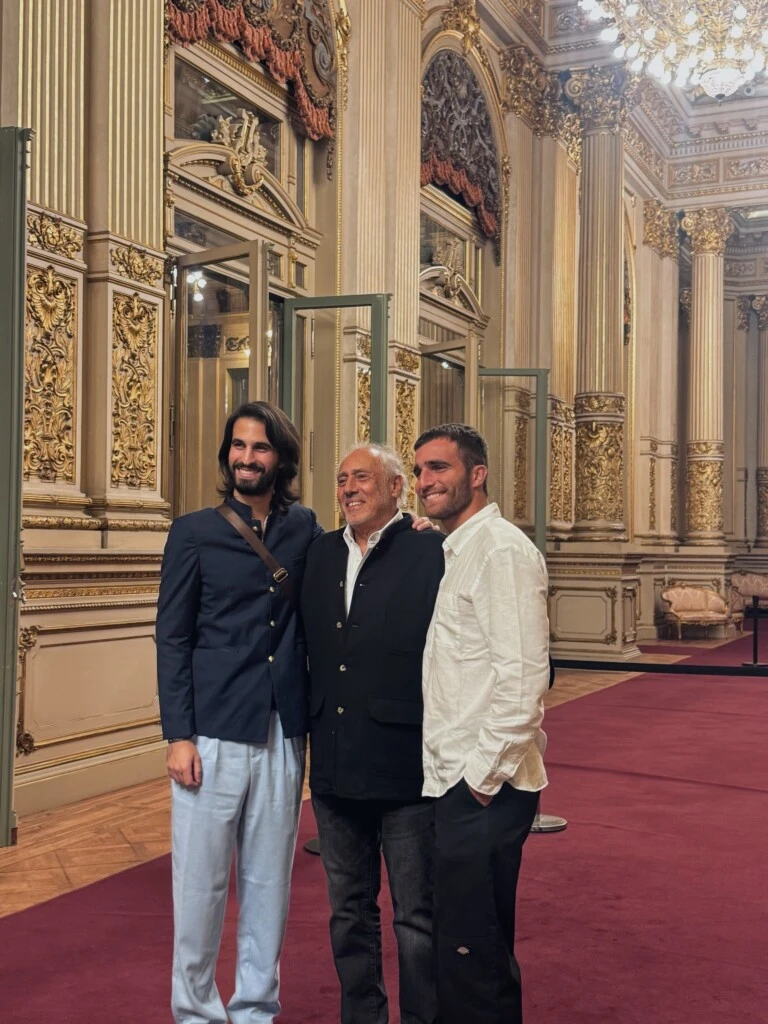 En la fotografía se puede ver al reconocido productor sonriente en el centro, flanqueado por los hermanos en los extremos, quienes imitan su gesto en una escena de absoluta complicidad que el piloto quiso enmarcar en su perfil.